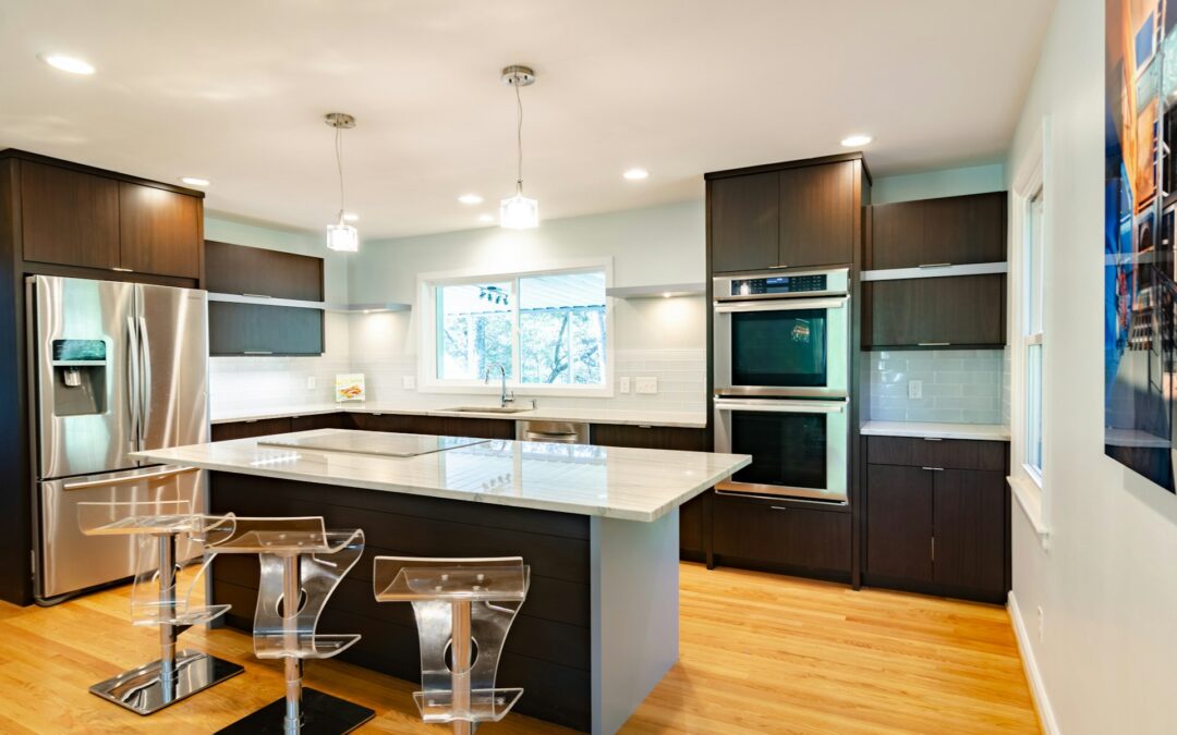 A photo of a kitchen with a three clear glass bar stool
