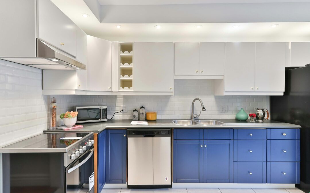 A photo of a kitchen with white and blue cabinets