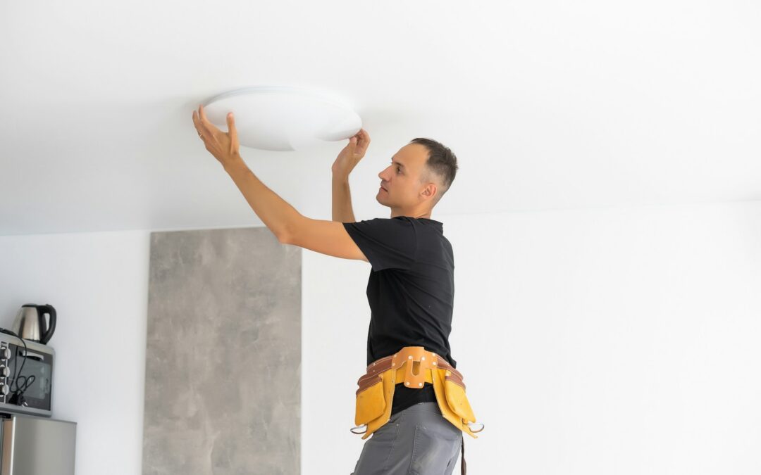 A person changing a ceiling light